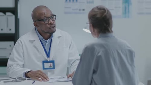 Doctor Explaining Medical Records to Patient