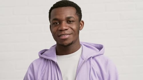 Young Man Smiling Wearing Hoodie Indoors