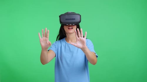 Woman Exploring Virtual Reality with Headset on Green Screen