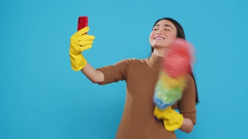 Woman Poses for Selfies with Feather Duster