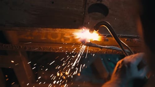 An Industrial Worker Cuts Steel with an Oxygen Torch