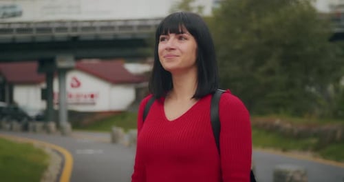 Woman Smiles Near Park in City