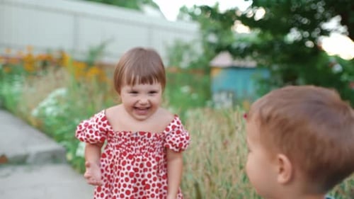 Happy Girl Playing With Balloon Outdoors With Friend