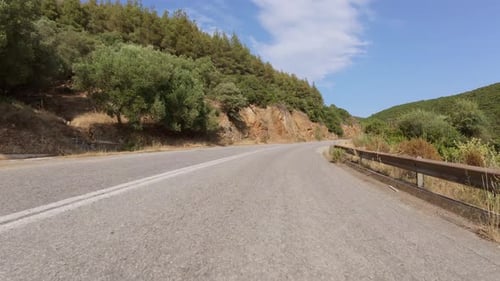 Scenic Coastal Road View From a Moving Car with Sea in the Distance Rocky Cliffs on One Side and Dry