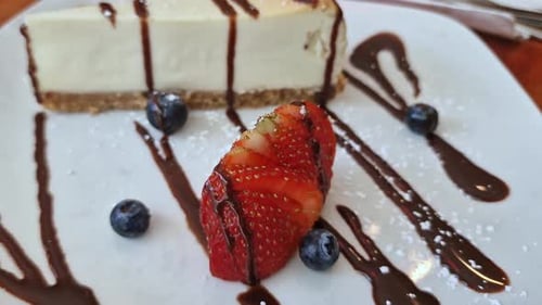 American Cheesecake With Toppings, Strawberry and Blueberries on Plate, Close Up