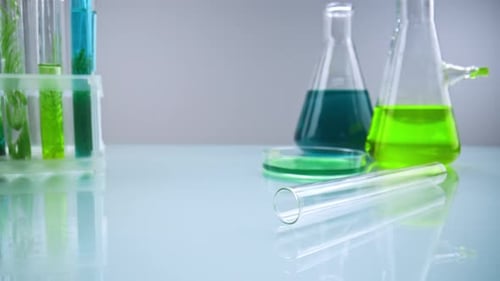 Laboratory Flasks and Test Tubes with Green and Blue Liquids