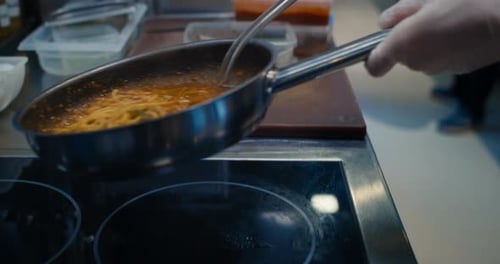 Chef Cooking Spaghetti in a Restaurant Kitchen
