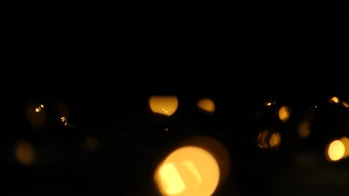 Abstract Bokeh Lights Shimmering on Black Background