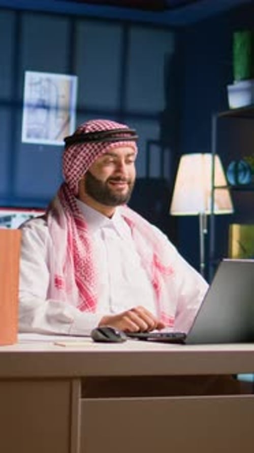 Young Adult in Headdress Using Laptop for Video Call