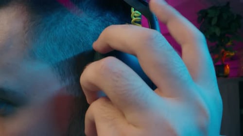 Young Adult Putting on Headphones in a Neon Room