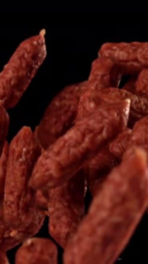 Mini Salami Fly and Fall on a Black Background Filmed on a Highspeed Camera at 1000 Fps