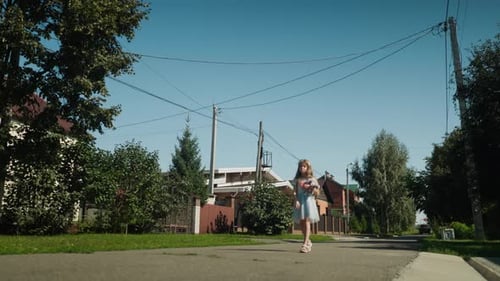 Kid Walking with Teddy Alone on Quiet Sunny Street