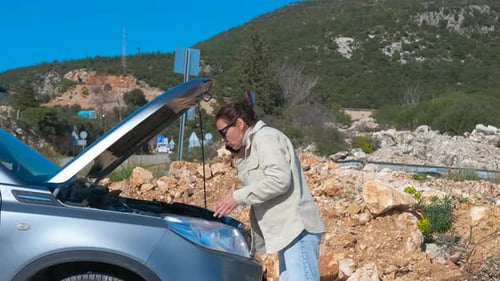 Woman with car trouble calls for roadside assistance