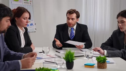 Business Meeting with Four People in Office Setting