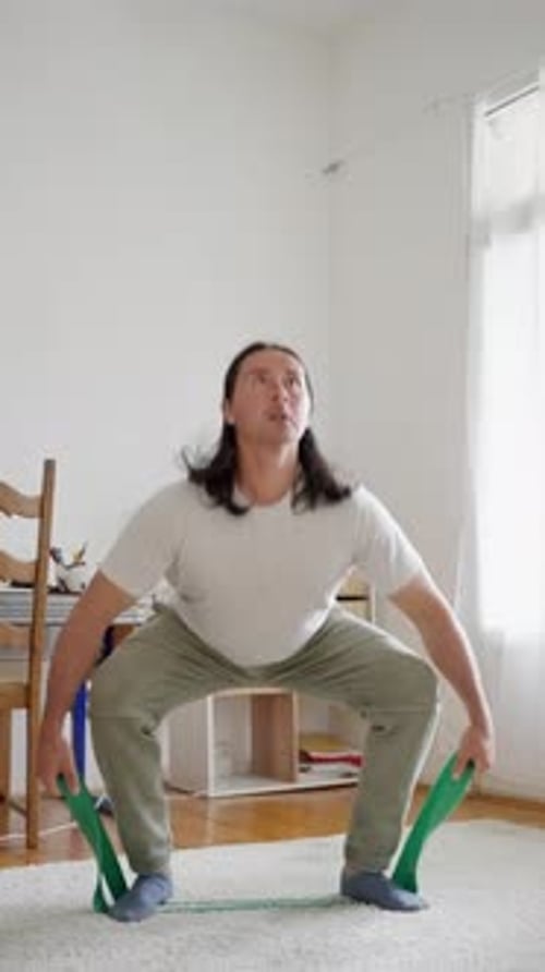 Adult Doing Squats with Resistance Band at Home