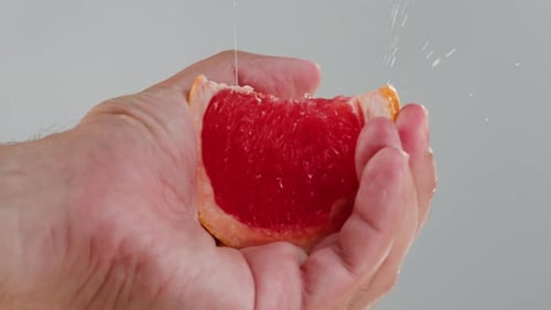 Close up of Hand Holding Juicy Grapefruit