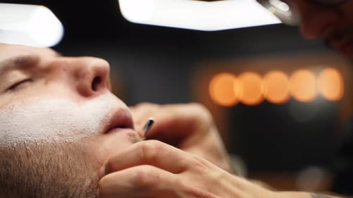 Man Gets Beard Trimmed at Barbershop