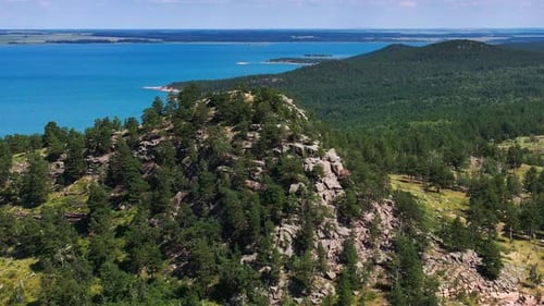 Mountain Lake And Rocky Hills Amid A Pine Forest