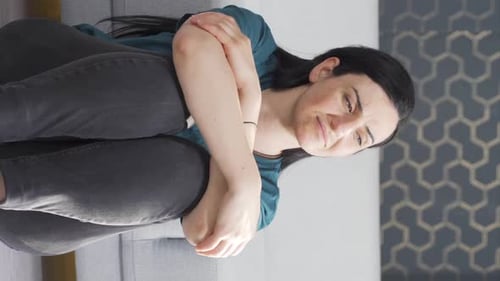 Adult Woman Looking Stressed at Home on Couch