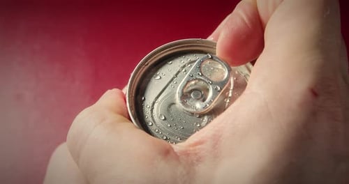 Fingers Open a Tin Can of Drink Closeup Alcoholic and Nonalcoholic Drinks Top View of Hand Opens Red