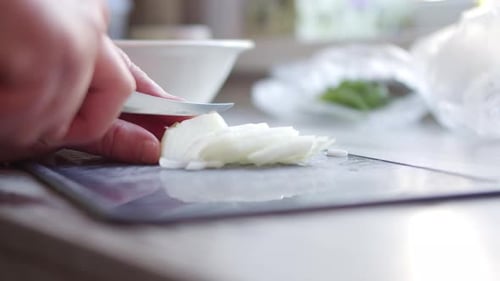 Chopping White Onion on Kitchen Counter