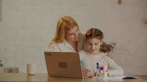 Child Learning on Laptop With Mother at Home