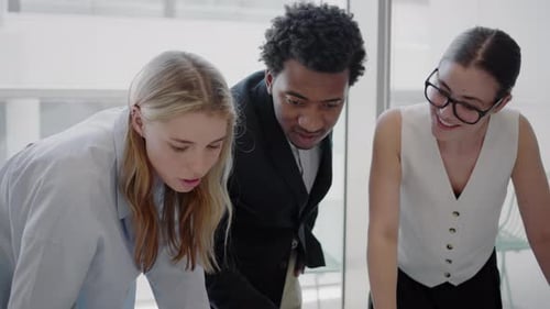 Smiling Colleagues Collaborating in Modern Workplace