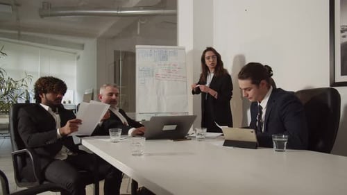 Professionals Discussing Data During Office Meeting