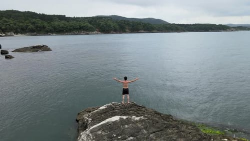 swimming person on rock