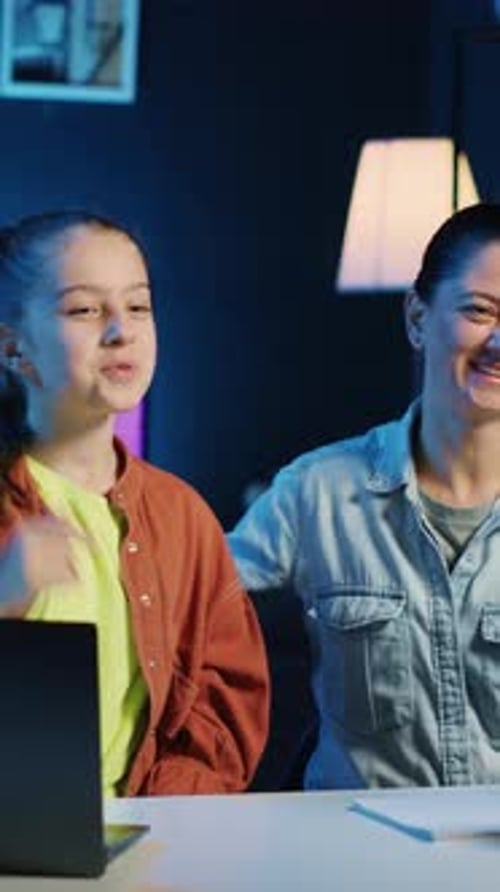 Child and Mother Cheer for Computer Success