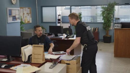 Police officers discussing a case in the cop shop