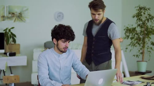 Young Men Working Together in an Office
