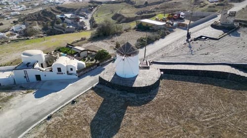 Aerial view of windmills and white building, Greece.