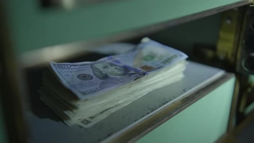 Stack of Cash Inside Teal Safe