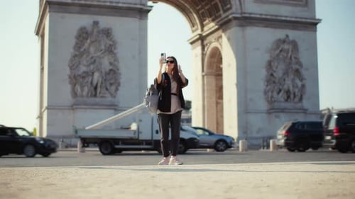 A Beautiful Woman Taking a Picture Near the Arc De Triomphe in Paris
