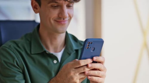 Young Adult Using a Smartphone Indoors