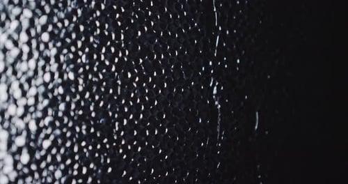 Abstract black bumpy texture with shiny small dots