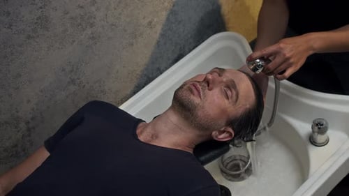 Man Gets Hair Washed at Stylish Salon