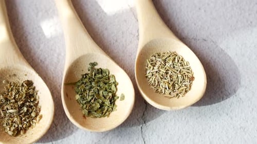 Close Up of Herbs in Wooden Spoons
