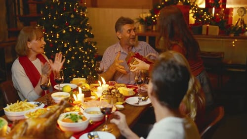 Family Celebrates Christmas with Gifts and Festive Dinner