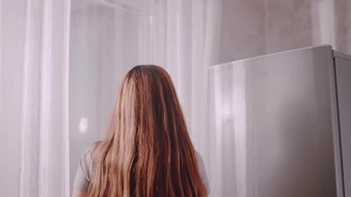 Lady Taking Bread From Fridge and Closing Door