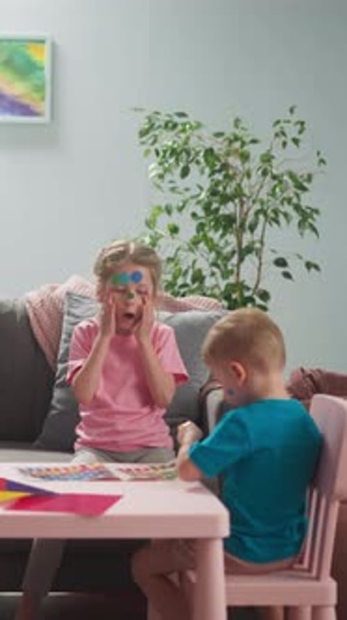 Woman Works on Laptop Neglecting Playful Children in Room