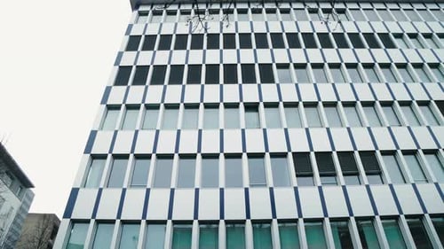 Glass Exterior of a Contemporary Skyscraper Revealing Dynamic Interplay of Architecture in Heart of