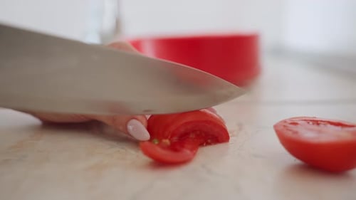 Close Up of Chef Slicing Fresh Tomato in Kitchen