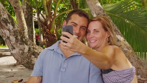 Couple Taking Photo Together at Tropical Beach America