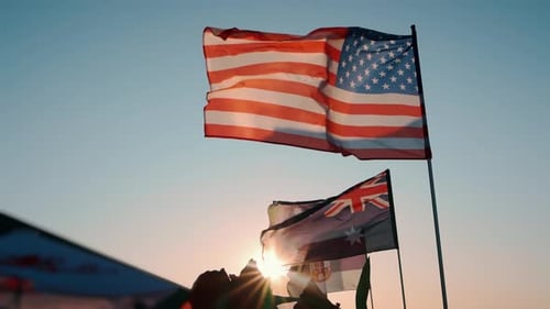 Flags Waving in the Wind at Sunrise or Sunset