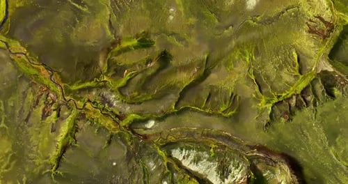 Ancient Mossy River Veins Across A Vast Volcanic Icelandic Landscape