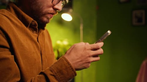Vintage young latin male texting on his phone