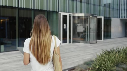 Blond Student Girl with Books Walking to the University Building Happy Smiling Woman Looking at