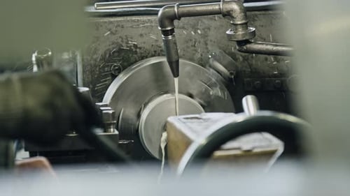 Skilled machinist using lathe machine in industrial setting